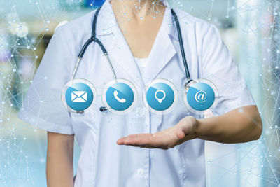 Picture of a female nurse in scrubs with a stethoscope around her neck holding up contact icons