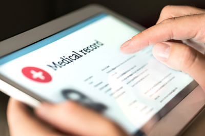 Picture of female looking at medical records on a tablet