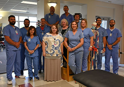 Picture of The Rehabilitation Services Staff (male and female) wearing scrubs looking at the camera