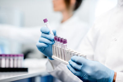 Picture of a female in laboratory holding test tubes