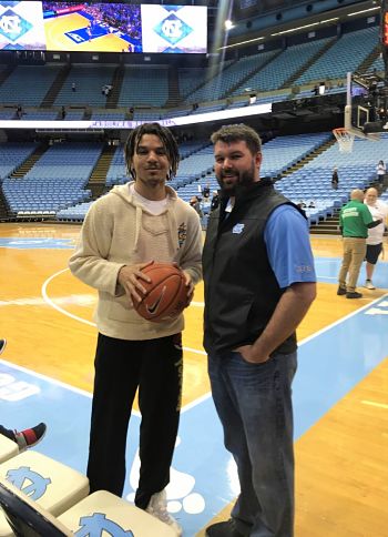 Picture of Dustin Absher. He is enjoying a courtside seat to the interworking of one of high school basketball's most storied programs