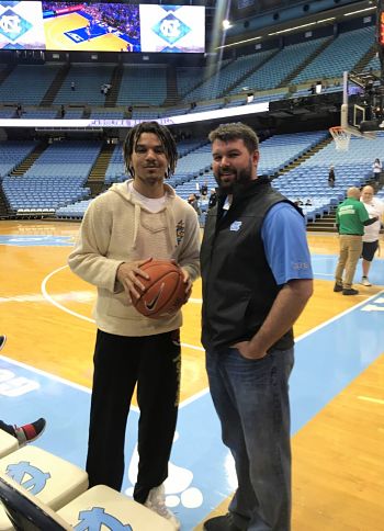 Picture of Dustin Absher. He is enjoying a courtside seat to the interworking of one of high school basketball&apos;s most storied programs