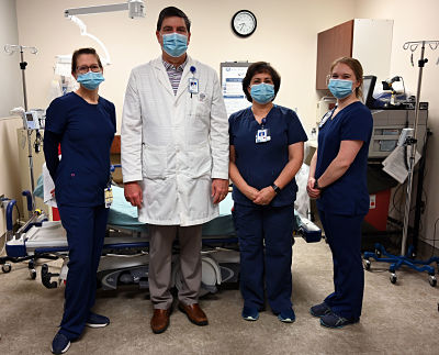 Ashe Memorial Hospital medical director and emergency room physician Dr. Brent Rody typically completes 15 clinical shifts a month, the majority of which are spent at Ashe Memorial.Picture of Ashe Memorial Hospital Medical Director and Emergency Room Physician, Dr. Brent Rody and three female Nurses standing in a Hospital Room