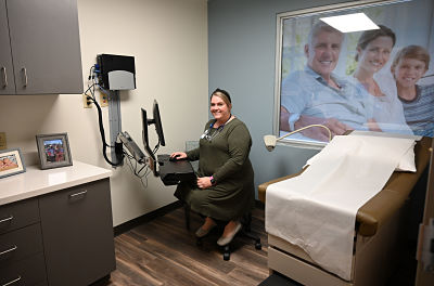 Ashe County native Katie Miller, a certified family nurse practitioner, is now helping care for those who supported her growing up as the provider for Fleetwood Family Medicine.Katie Miller, Provider for Fleetwood Family Medicine, sitting in patient room using some medical equipment while smiling over at the camera