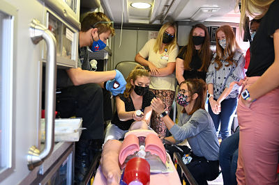 Picture of Ashe County High School students gathered around in an ambulance with a female EMT training them with a dummy on a stretcher.
Ashe County High School students gained valuable insight into the healthcare field during Ashe Memorial Hospital's Camp Med Summer Program July 12-16.