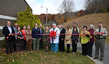 Picture of Ashe Memorial Hospital Urology Staff standing outside with a ribbon to be cut for The New Opening!