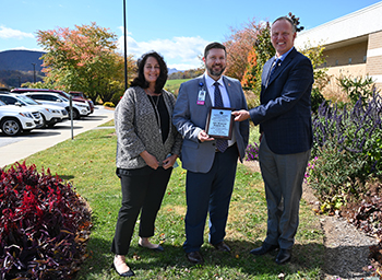 Ashe Memorial Hospital receives safety award. There is one female and two males smiling.