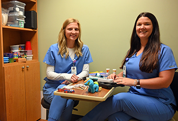 Speech language pathologists Sydney Grubb, M.S., CF-SLP, and Hannah Osborne, M.S., CCC-SLP, are expanding Ashe Memorial Hospital's speech therapy program to include pediatric speech therapy.Speech language pathologists Sydney Grubb, M.S., CF-SLP, and Hannah Osborne, M.S., CCC-SLP, sit with some of the items they use when working with speech therapy patients.