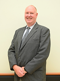 Aaron Glenn brings more than 20 years of nursing and leadership experience to Ashe Memorial Hospital.Headshot of male chief nursing officer standing in a suit with his hands crossed in front of him.